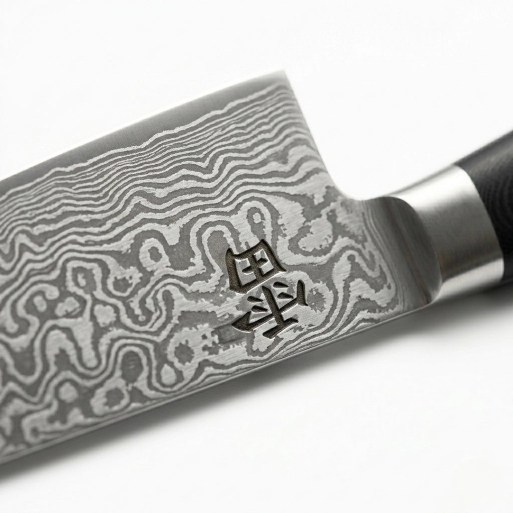Kaminari Damascus chef knife blade close-up showing layered Damascus steel pattern