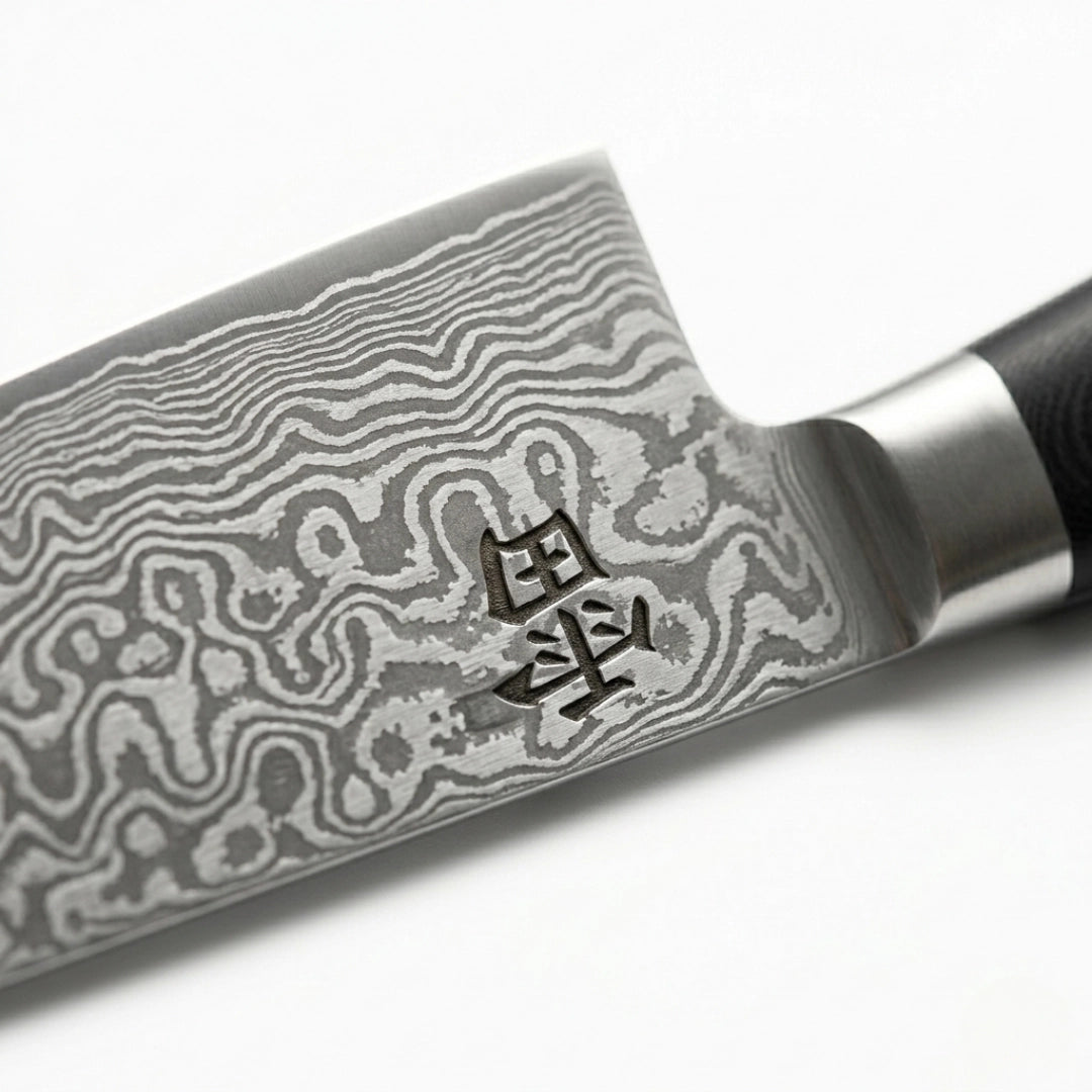 Kaminari Damascus chef knife blade close-up showing layered Damascus steel pattern