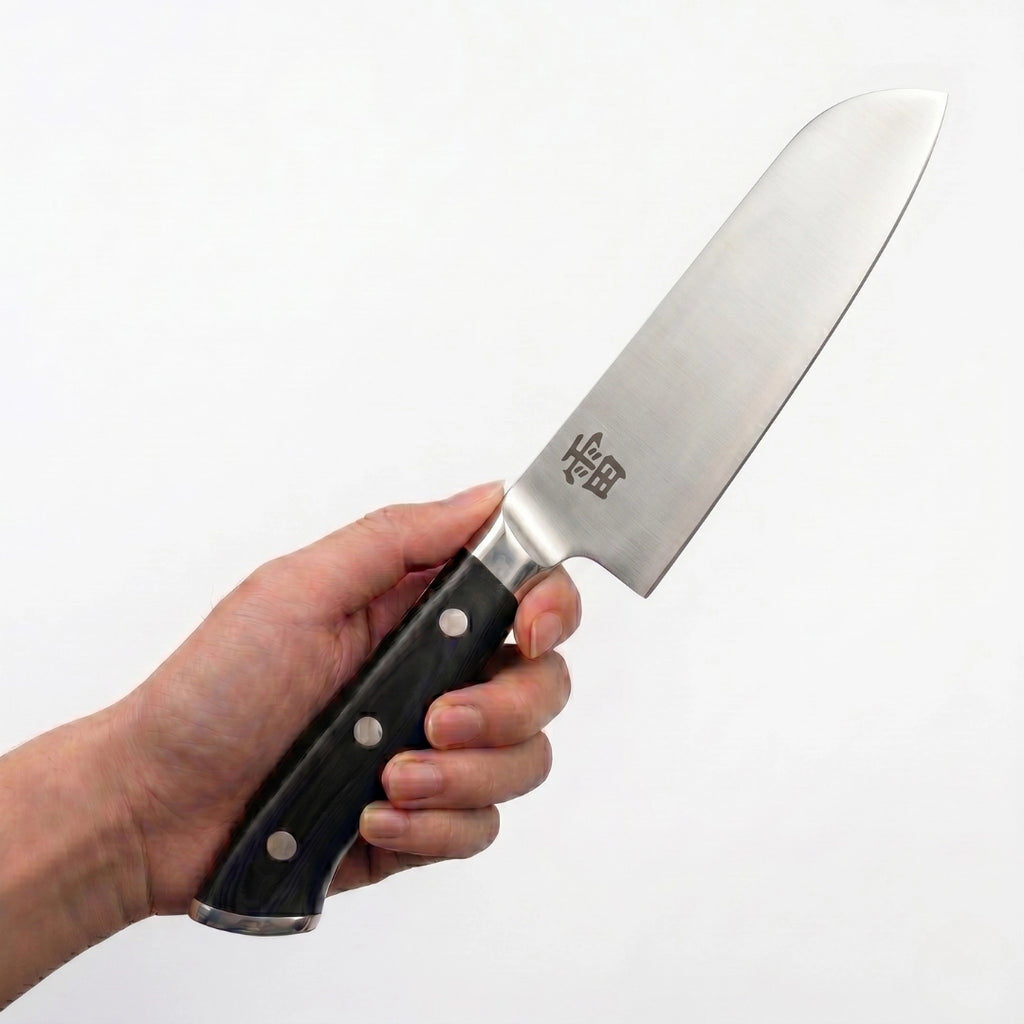 Kaminari 7-inch santoku knife in use slicing vegetables in kitchen